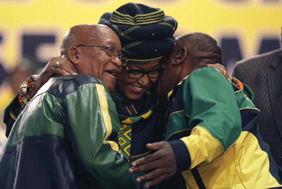 Winnie Madikizela-Mandela, center, hugs front runner and Deputy President, Cyril Ramaphosa, right, and President Jacob Zuma, left, at the start of the ruling African National Congress (ANC) elective conference in Johannesburg, Saturday, Dec. 16 2017. (AP)