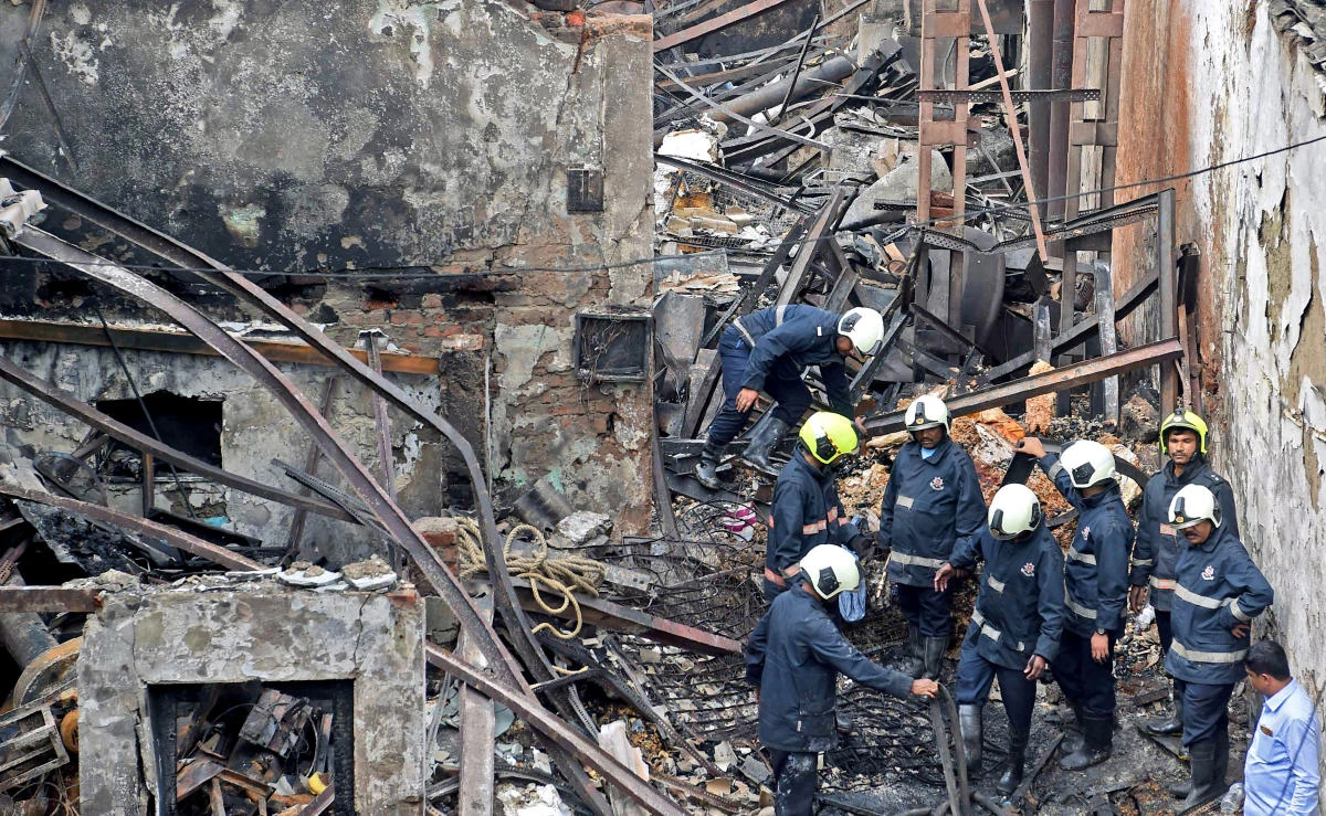 Indian firemen inspect the scene of a fire in Mumbai, Dec.18, 2017. (AFP)