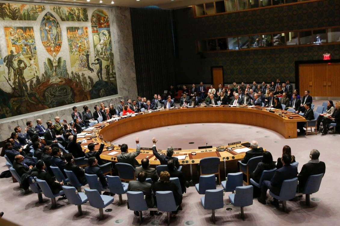 Members of the UN Security Council raise their hands as they vote on a draft resolution that would reject US President Donald Trump's decision to recognize Jerusalem as the capital of Israel during a meeting on the situation in the Middle East including Palestine on December 18, 2017, at UN Headquarters in New York. (AFP)