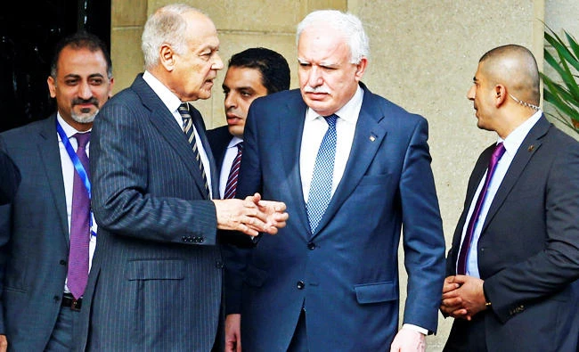 Arab League Secretary General Ahmed Aboul Gheit (L) with Palestinian National Authority Minister of Foreign Affairs Riyad Al Maliki are seen after a meeting with Palestine President Mahmoud Abbas in Cairo, Egypt, in this December 11, 2017 photo. (REUTERS)