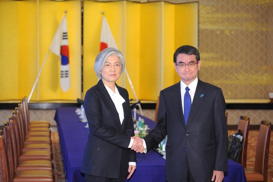 South Korean Foreign Minister Kang Kyung-wha (L) shakes hands with her Japanese counterpart Taro Kono as they attend the Japan-ROK Foreign Minister meeting at the ministry of foreign affairs in Tokyo on December 19, 2017. (AFP)