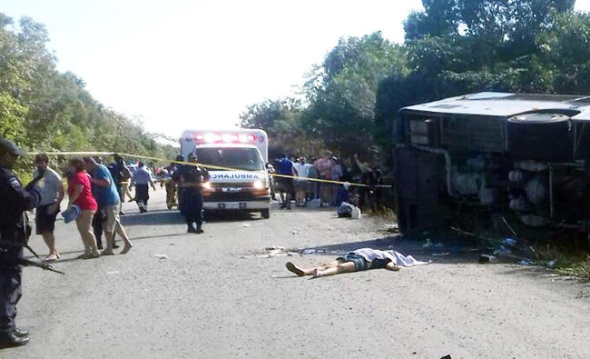 The body of one of the victims of a road accident lays on the floor, where a bus driving tourists to Chacchoben archaeological zone overturned between El Cafetal and Mahahual, in Quintana Roo state, Mexico on Tuesday. (AFP)
