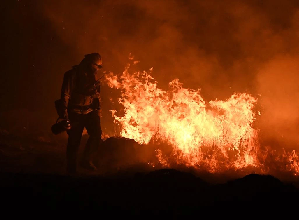 Above, firefighters light backfires as they try to contain the Thomas wildfire in Ojai, California — considered the second largest fire to hit the state since 1932. (AFP)