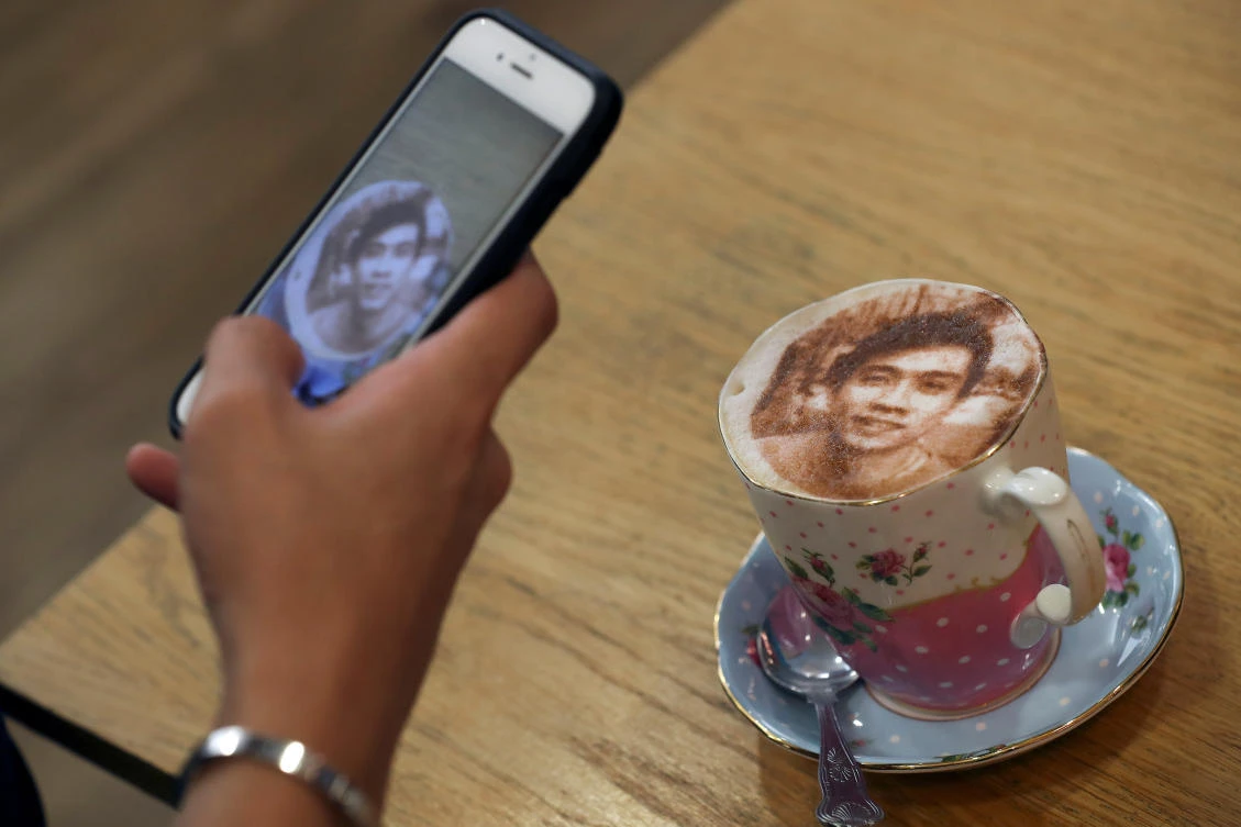 A customer takes a photograph of their ‘Selfieccino’ coffee at the Tea Terrace in London. Over 400 of the personalized drinks have been sold since they launched on Saturday, with the hashtag “Selfieccino” going viral across various social media platforms. (Reuters)