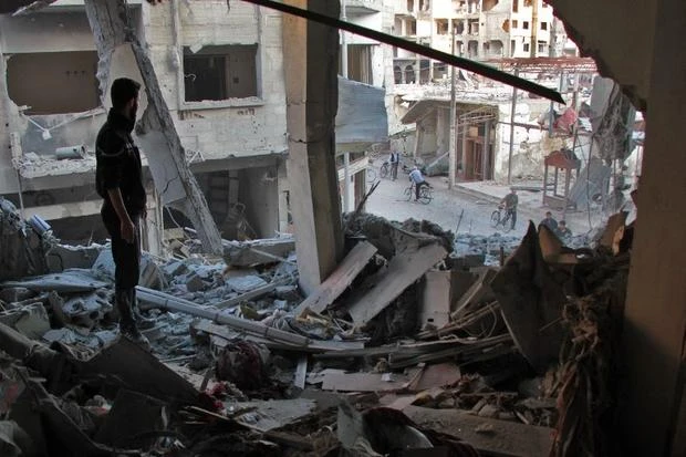 A Syrian man at the site of an air strike on 2 November in Douma. (File photo by AFP)