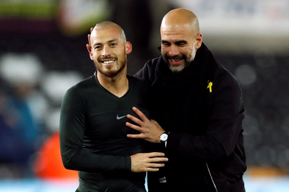 Manchester City manager Pep Guardiola celebrates with David Silva at the end of the Premier League win over Swansea. (Reuters)