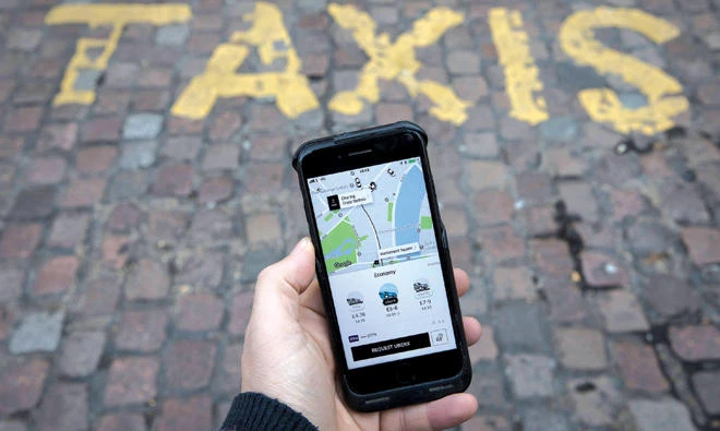 A photo illustration shows the Uber app on a mobile telephone. The ride hailing app has suffered another setback following an EU ruling. (Reuters)