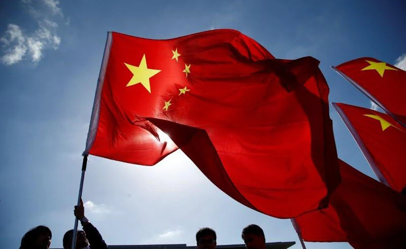 This file photo shows people holding Chinese flags in Berlin, Germany on June 16, 2017. (REUTERS)