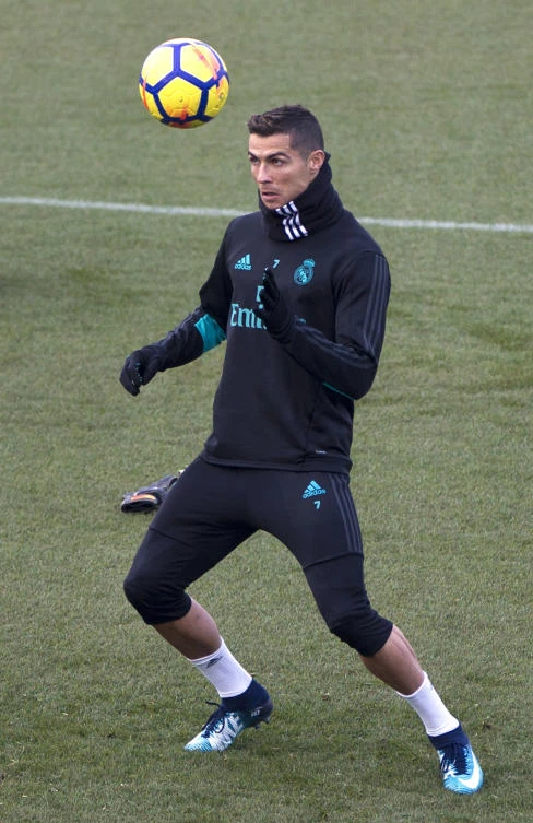 Real Madrid's Cristiano Ronaldo heads the ball during a training session in Madrid on Friday. (AP)