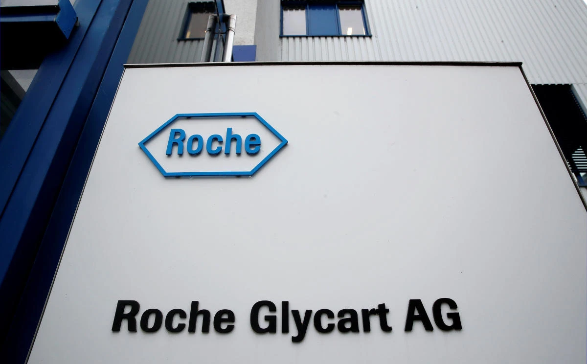 The logo of Swiss drugmaker Roche is seen beside the entrance of one its research units in Switzerland. The company is paying $27 per share for Ignyta, representing a premium of about 74 percent to the stock’s closing price on Thursday. (Reuters)