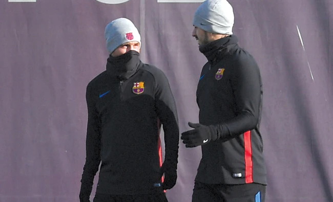 Barcelona stars Lionel Messi and Luis Suarez wrap up warm in their final training session before the crunch clash with Real Madrid. (AFP)