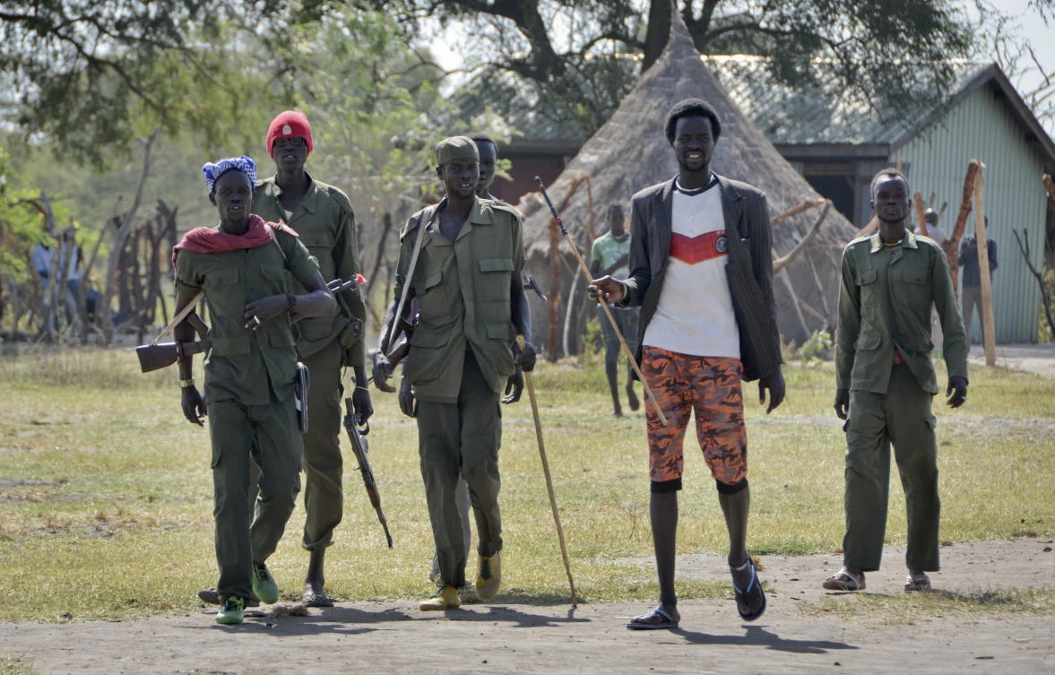 Armed opposition soldiers walk in Jiech, Ayod County, South Suda. (AP Photo/Sam Mednick)
