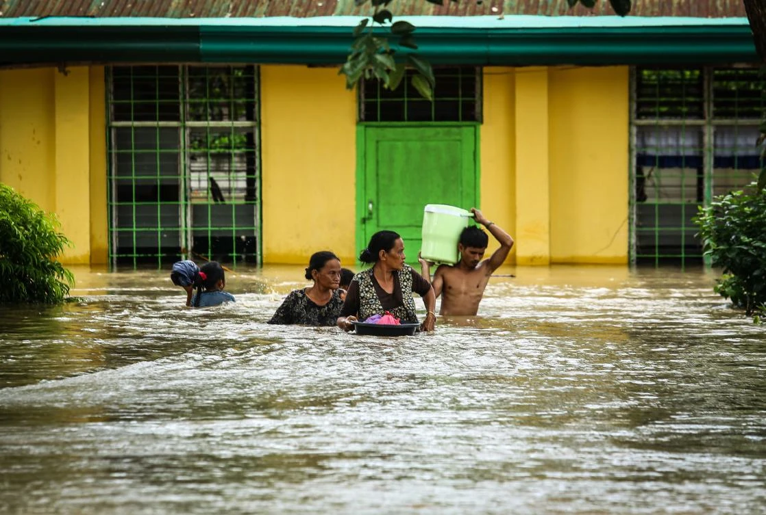 Residents evacuate to a safer place in Kabacan, North Cotabato, on the southern island of Mindanao on December 23, 2017, after Tropical Storm Tembin dumped torrential rains across the island. (AFP)