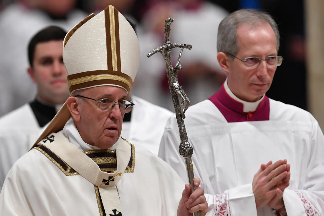 Pope Francis (C) looks on at the end of a mass on Christmas eve on December 24, 2017 at St. Peter’s basilica in Vatican. (AFP)