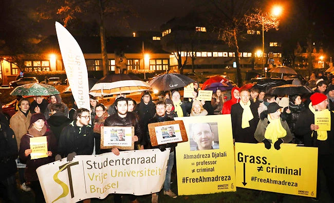 People take part in a rally, on December 14, 2017 at the Iranian embassy in Brussels, in support of Ahmadreza Djalali after Iran’s Supreme Court upheld the death sentence handed to this an Iranian-born Swedish resident and specialist in emergency medicine. (AFP)