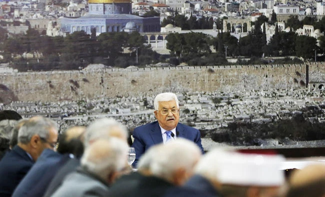 Palestinian Authority President Mahmud Abbas sits in front of a photo of the Dome of the Rock mosque in Jerusalem's Old City during a meeting of the Palestinian leadership in the West Bank city of Ramallah, in this December 18, 2017 photo. (AFP)