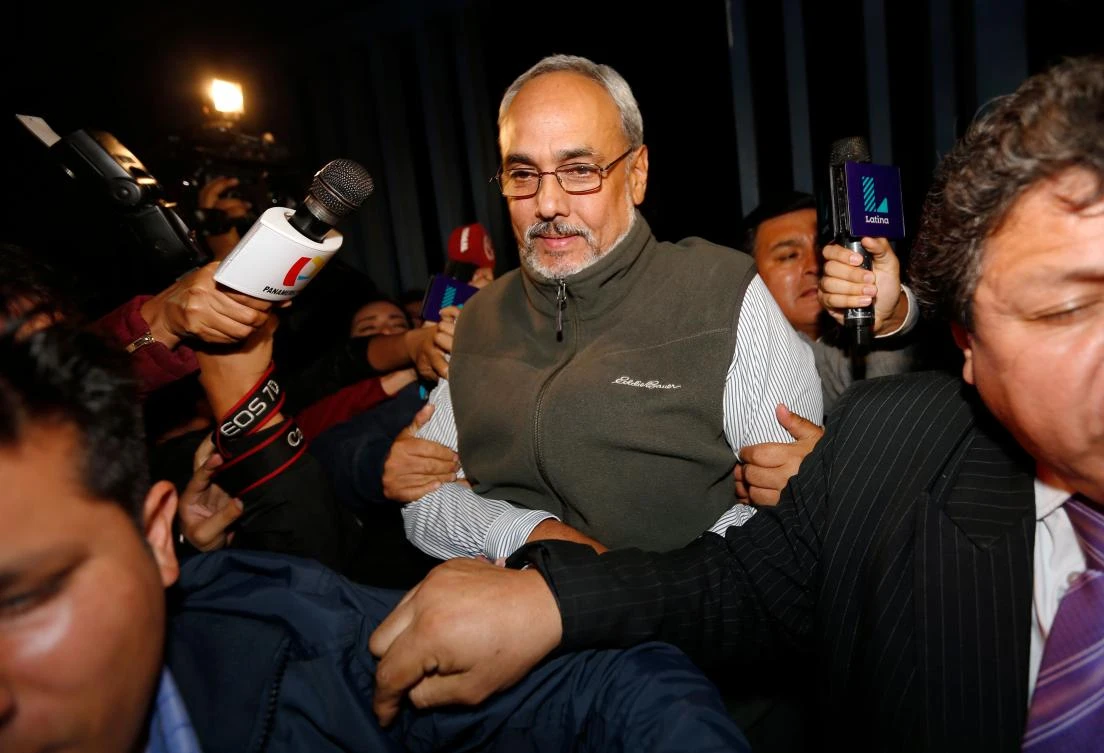 This file photo taken on December 7, 2015 shows the former president of the Peruvian Football Association, Manuel Burga (L), being taken to a courthouse from the police judiciary facility where he had been held since his arrest on an international warrant in Lima, Peru. (AFP)