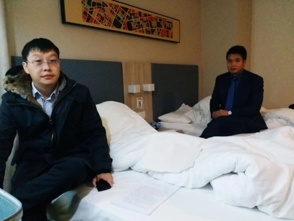 Yan Xin (L) and Ge Yongxi (R), lawyers for activist Wu Gan known by the online pseudonym “Super Vulgar Butcher,” sit at a hotel after Wu was sentenced at a court in Tianjin on December 26, 2017. (AFP)
