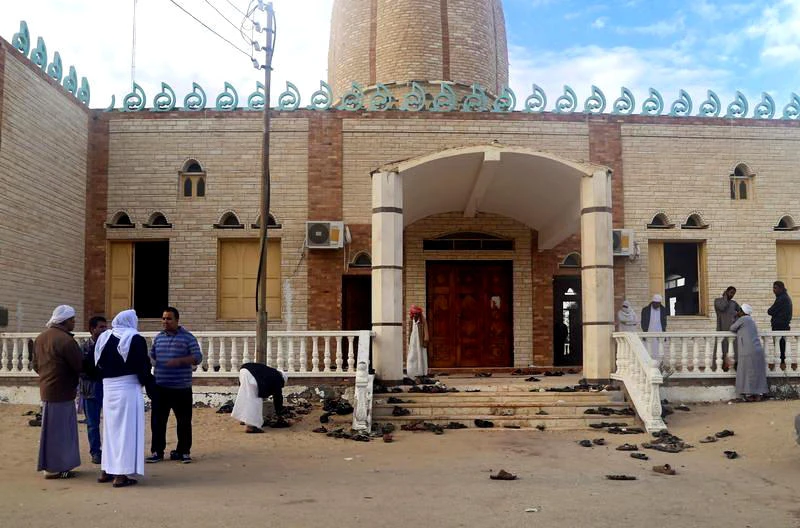 People stand outside Al Rawdah mosque, where a bomb exploded, in Bir Al-Abed, Egypt on Nov.25, 2017. (REUTERS)