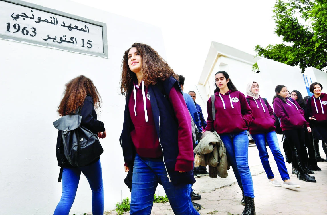 Siwar Tebourbi, center, an 18-year-old Tunisian schoolgirl, walks with colleagues as they leaveschool in Bizerte on Nov. 30, 2017. (AFP)