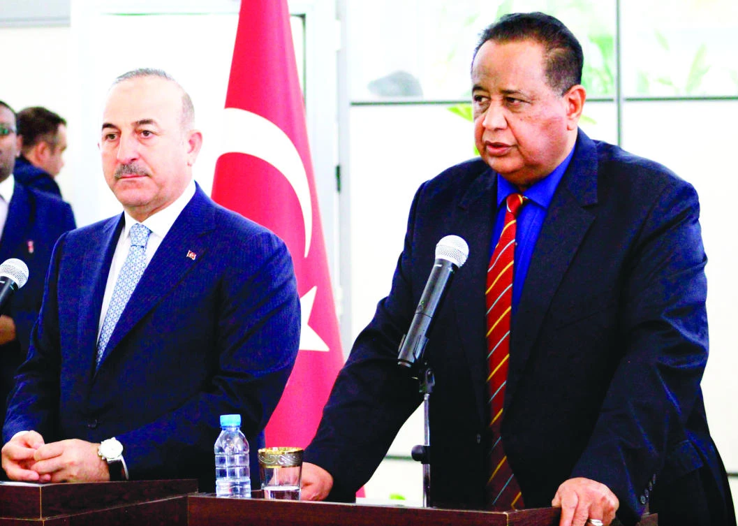 Sudanese Foreign Minister Ibrahim Ghandour, right, gives a press conference with his Turkish counterpart Mevlut Cavusoglu at Khartoum International Airport on Tuesday. (AFP)
