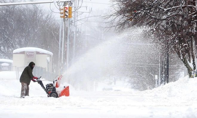 A man clears snow on Tuesday in Erie, Pa. (AP)
