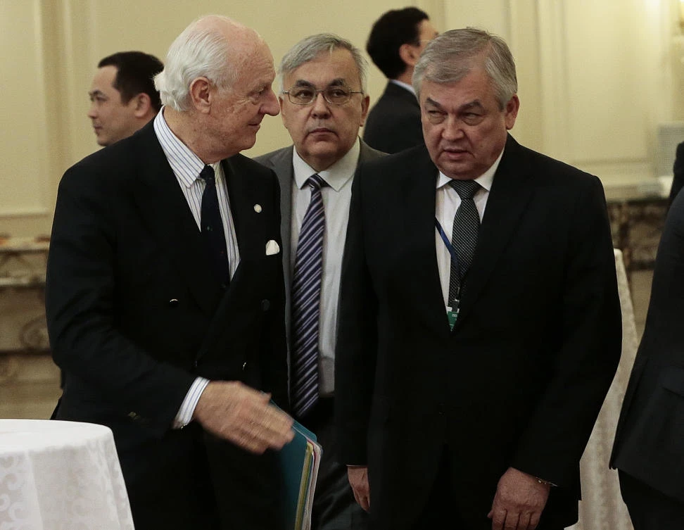 UN Special Envoy for Syria Staffan de Mistura (L) speaks with Russia's chief negotiator for Syria, Aleksandr Lavrentyev (R), during the session of Syria peace talks in Astana on Dec. 22, 2017. (AFP)