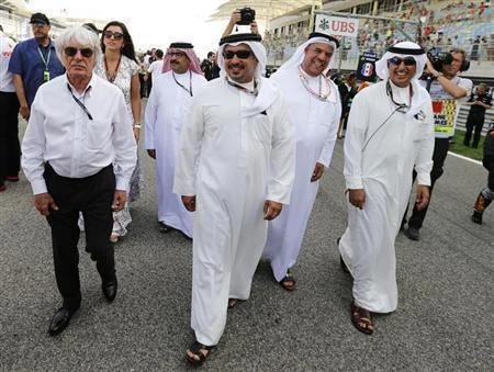 In this file photo, Bahrain’s Crown Prince Salman bin Hamad Al-Khalifa (C) walks with Formula One’s commercial supremo Bernie Ecclestone (L), Chairman of the Bahrain International Circuit Zayed Al-Zayani (R) and other officials in 2013. (Reuters)