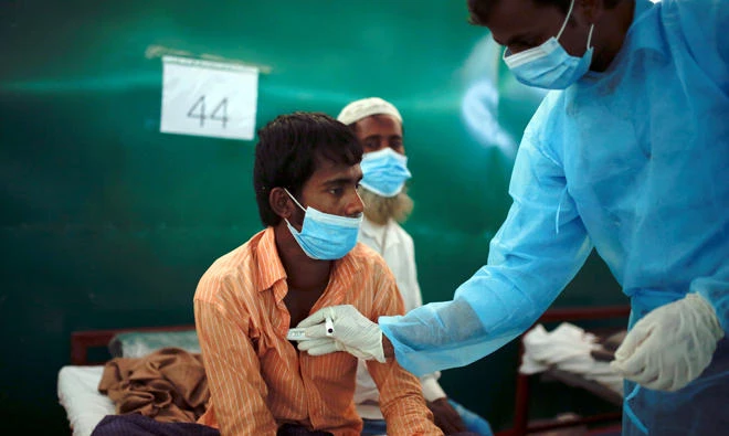 Rohingya refugee Nur Islam, 24, who suffers from diphtheria, is examined by a doctor at a Medecins Sans Frontieres (MSF) clinic near Cox's Bazar, Banglades, in this Dec. 18 file photo. (Reuters)