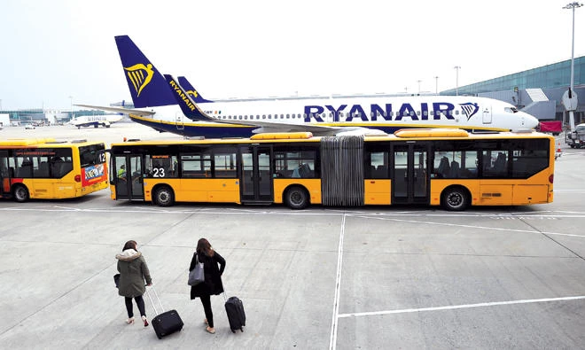 People disembark from a Ryanair flight to board a bus at Stansted Airport in London. Emirates planes will also soon become a familiar sight at the airport that is better known for the budget end of the aviation business. (Reuters)