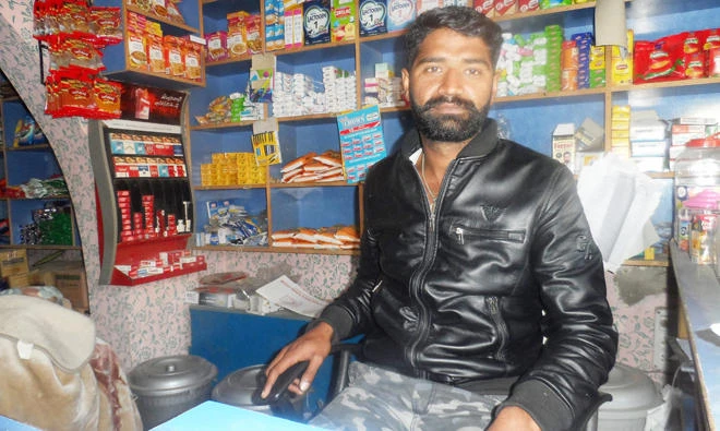 Khizar Abbas, 28, runs a general store in his village in Mandranwala, Sialkot district, after his dream to reach Italy was shattered following his arrest in Iran. (AN photo)
