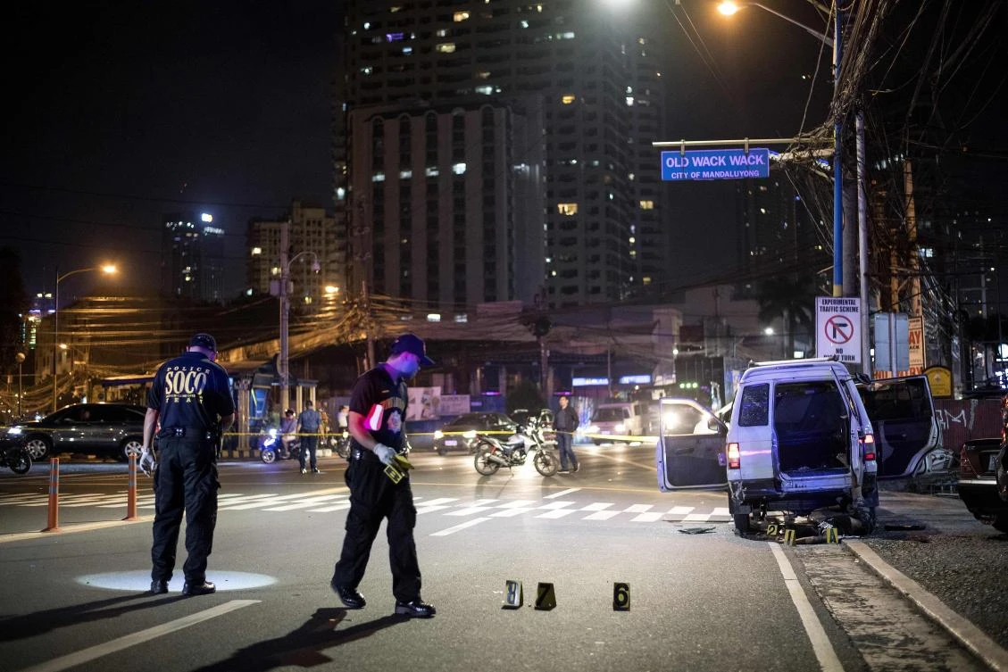 Above, investigators inspect the crime scene as the body of a man, right, lies on the ground after local officials and police opened fire on a vehicle carrying a woman wounded in a separate shooting incident. (AFP)