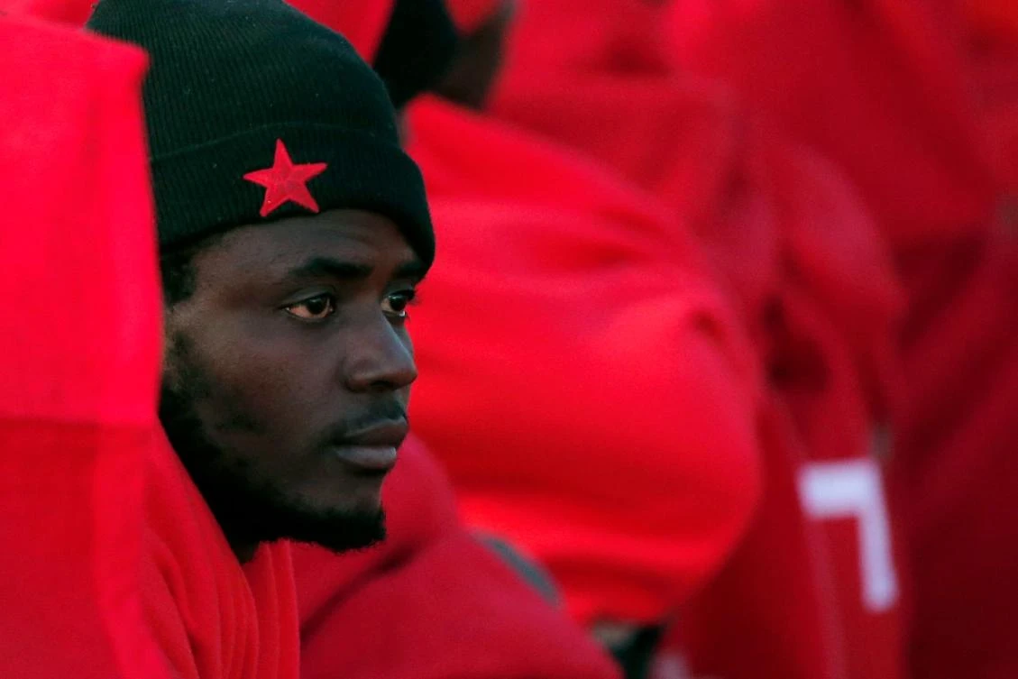 A migrant keeping warm in a Red Cross blanket after arriving aboard a coast guard boat at Malaga’s harbor after an inflatable boat carrying 47 men, 7 women and 1 child was rescued by the Spanish coast guard off the Spanish coast. (AFP)
