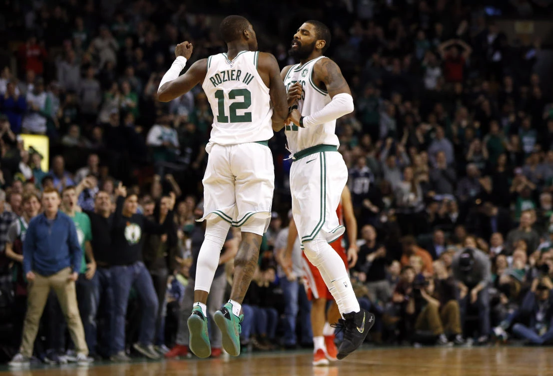 Boston Celtics’ Terry Rozier and Kyrie Irving jump in the air in celebration of a basket during the second half against the Houston Rockets at TD Garden on Thursday. (USA TODAY Sports)