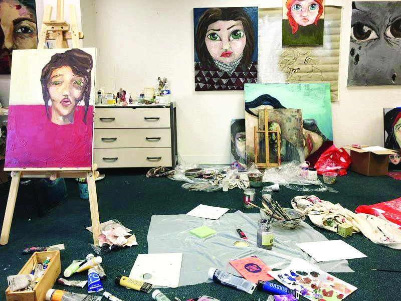 Paintings by refugees displayed at the Agency for Artists in Exile in northern Paris on Friday. (Reuters)