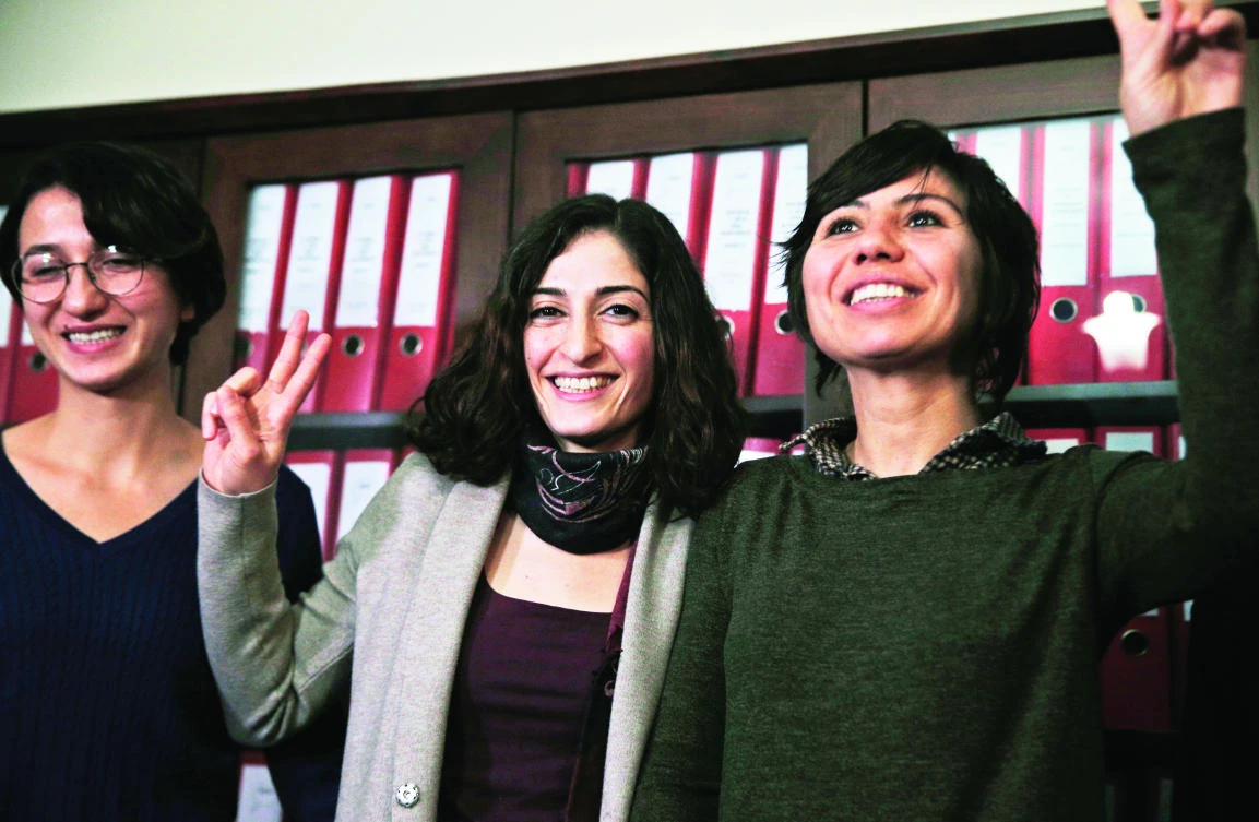 German journalist Mesale Tolu, center, accompanied by friends, poses for pictures after she was released from prison in Istanbul on Monday. (AP)