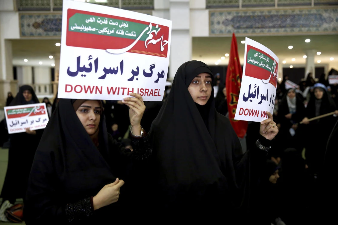 Iranian protesters hold anti-Israeli placards at a rally in Tehran, Iran, Saturday, Dec. 30, 2017. Iranian hard-liners rallied Saturday to support the country's supreme leader and clerically overseen government as spontaneous protests sparked by anger over the country's ailing economy roiled major cities in the Islamic Republic. (AP Photo/Ebrahim Noroozi)