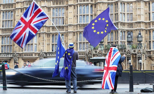Pro-European Union, (EU), anti-Brexit demonstrators hold Union and EU flags outside the Houses of Parliament in central London, in this December 21, 2017 photo. (AFP)