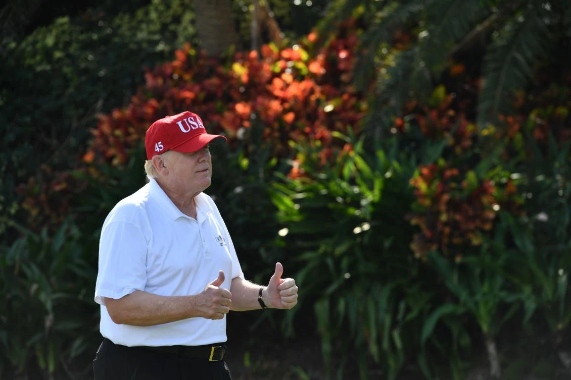 President Donald Trump holds two thumbs up while meeting with service members of the US Coast Guard in Mar-a-Lago, Florida on December 29. (AFP)