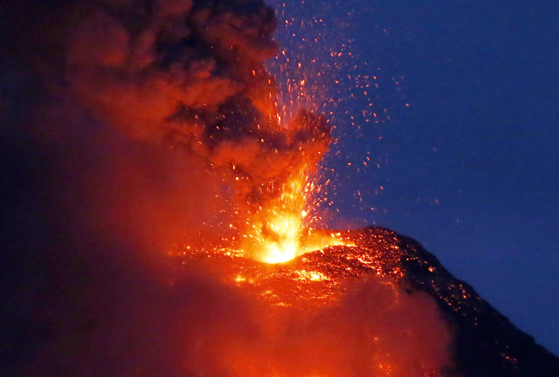 Mayon volcano spews red hot lava in another eruption as seen from Legazpi city, Albay province, roughly 200 miles (340 kilometers) southeast of Manila, Philippines, Tuesday, Jan. 23, 2018. Mayon has spewed fountains of red-hot lava and massive ash plumes anew in a dazzling but increasingly dangerous eruption that has sent 56,000 villagers fleeing to evacuation centers. (AP Photo/Bullit Marquez)