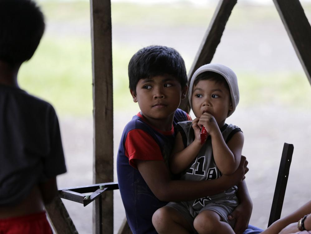 epa06445669 Filipino evacuees take shelter at a school next to rumbling Mayon Volcano in the town of Camalig, Albay province, Philippines, 17 January 2018. Philippine Institute of Volcanology and Seismology Agency (PHIVOLCS) maintained the alert level at 3 (critical) on a scale of 5, citing an imminent major volcanic eruption, although it could take days or even weeks to occur. A total of 15,410 people living within a six-kilometer radius of the crater, which has been designated as a danger zone, have been evacuated and housed in temporary shelters, schools and sports centers in the region. The government of the Albay province declared a state of calamity on 16 January. EPA/FRANCIS R. MALASIG