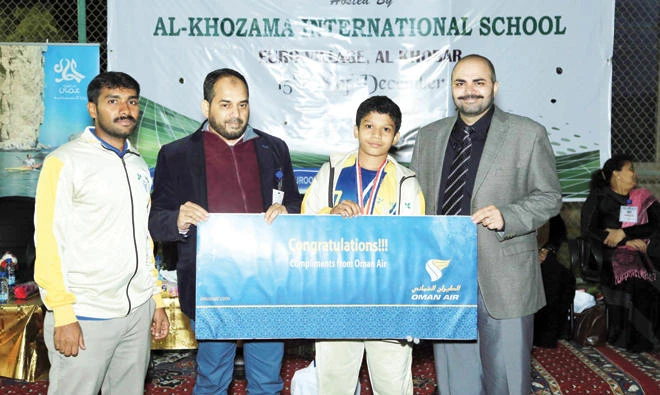 Master Shuhaib receives his award from Oman Air officials.