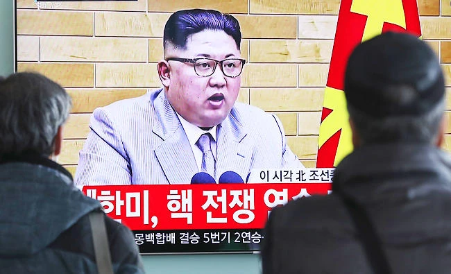 South Koreans watch a TV news program showing North Korean leader Kim Jong Un's New Year's address, at the Seoul Railway Station in Seoul, South Korea, on Monday. (AP)