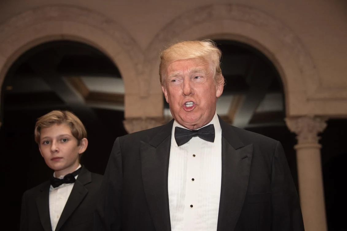 US President Donald Trump and son Barrin arrive for a new year's party at Trump's Mar-a-Lago resort in Palm Beach, Florida, on December 31, 2017. (AFP)