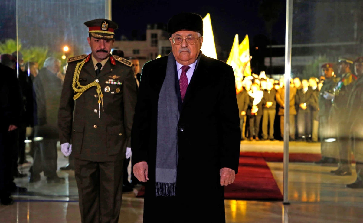 Palestinian president Mahmud Abbas, center, looks on after laying a wreath of flowers on the tomb of the late President Yasser Arafat during a celebration marking the fifty-third anniversary of the creation of the Fatah movement in the West Bank city of Ramallah on Dec. 31, 2017. (AFP)