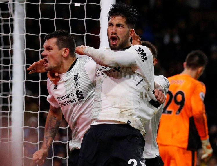 Liverpool's Dejan Lovren and Emre Can celebrate after Ragnar Klavan scored their second goal at Burnley. (Reuters)