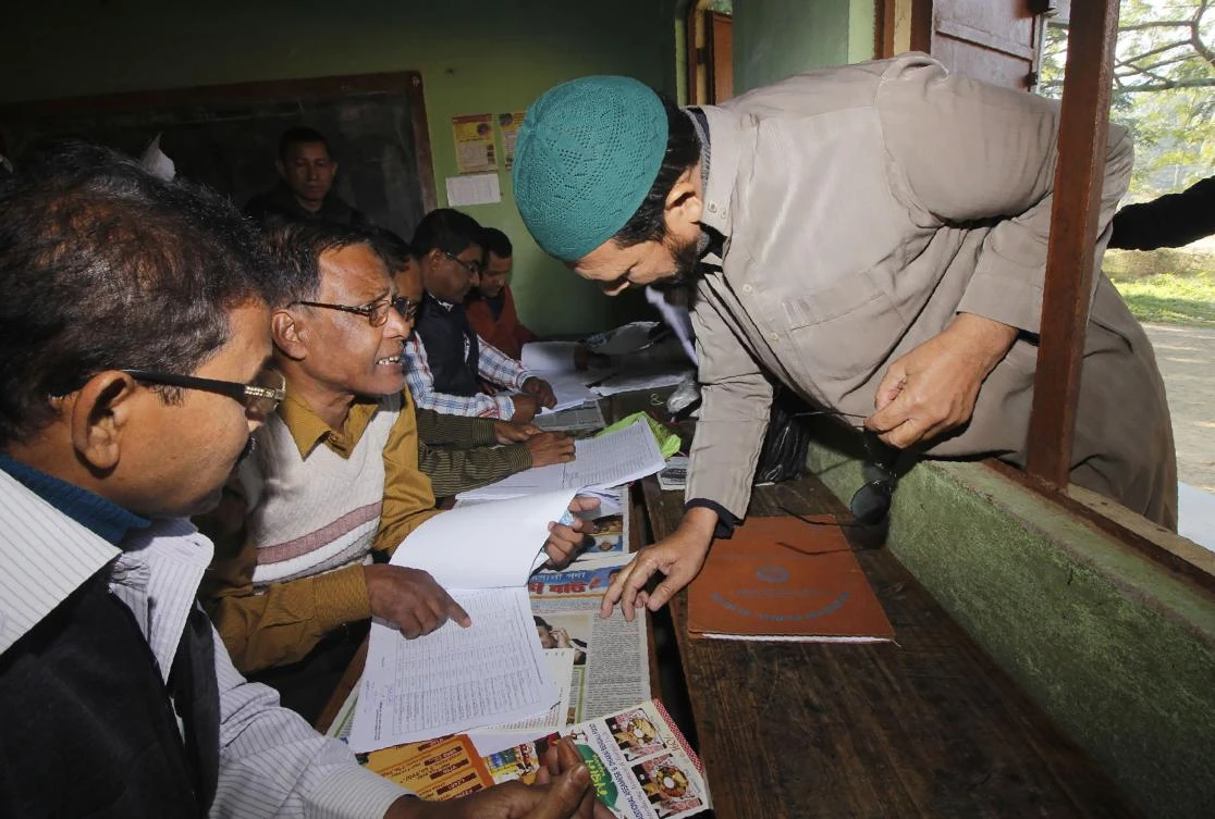 A man looks for his name on the first draft of the National Register of Citizens (NRC) in Guwahati in the Indian state of Assam on January 1, 2018. (AFP)
