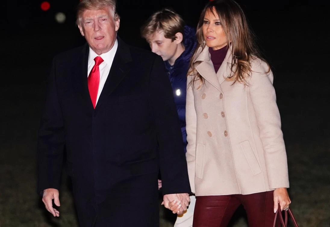 US President Donald Trump, First Lady Melania Trump and son Barron walk across the South Lawn upon return to the White House in Washington, DC on Jan. 1, 2018, after vacationing at the Mar-a-Lago estate in Florida. (AFP/Mandel Ngan)