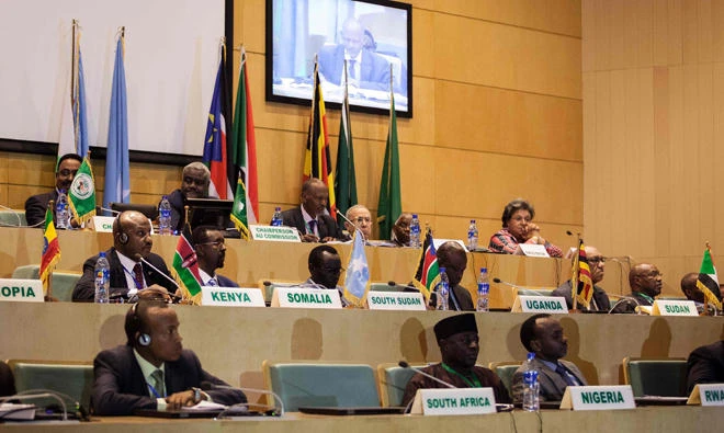 African Union chairman Moussa Faki (2nd L-top) sitting with members of the Intergovernmental Authority for Development (IGAD) as they attend a signing ceremony for the ceasefire agreement amongst South Sudanese parties to end the four-year war in the country, at the headquarters of African Union in the Ethiopian capital Addis Ababa. (AFP)