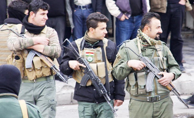 Iraqi Kurdish security forces stand guard during a protest in Sulaimaniyah, in the Kurdish autonomous region of northern Iraq, on December 19, 2017. (AFP)